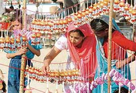Women pick out decorative hangings during a Dasehra mela in Ludhiana on Monday.