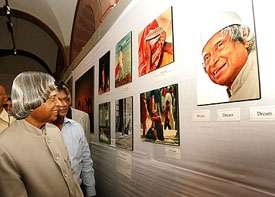 President A.P.J Abdul Kalam looks at a picture of himself as he inaugurates an exhibition at Rashtrapati Bhavan in New Delhi on Monday to commemorate the birth anniversary of Mahatma Gandhi