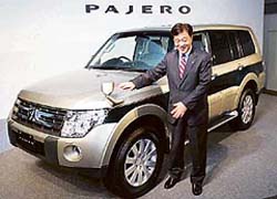 Mr Osamu Masuko, President, Mitsubishi Motors Co., poses with fully redesigned new Pajero in Tokyo