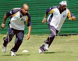 Sanath Jayasuriya and Muttiah Muralitharan do warm-up exercises at the PCA Stadium in Mohali on Wednesday