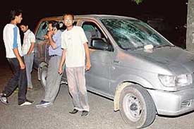 Occupants of a Travera standing besides their smashed vehicle at the Sector 33 and 34 intersection late on Wednesday night