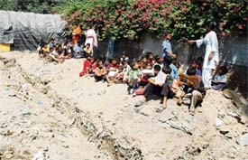 Slum children attend a class in the open in Ludhiana