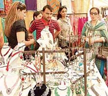 People admire display of jewellery at a stall during the Carnival of Lights in Ludhiana on Friday. 