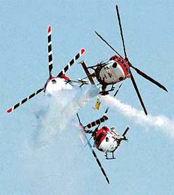 Four Dhruv helicopters perform formation manoeuvres on the eve of Air Force Day at Hindon Air Force Station, near Delhi