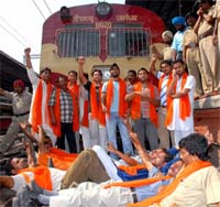 Shiv Sena activists block a train in protest against the alleged burning of effigies of Lord Rama, Sita and Hanuman on Dasehra at Bathinda, in Amritsar railway station on Sunday.