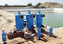 A view of a reservoir and a drip irrigation unit on 95-acre farm at Tahliwala Jatta village near Fazilka.