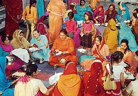 Women participate in the Karva Chauth puja at a temple in Sector 38, Chandigarh