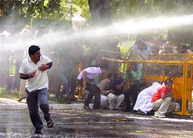 The police use water cannons to disperse activists of the Bharatiya Janata Yuva Morcha during a demonstration