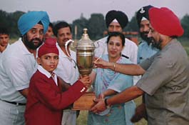 The chief guest presents the overall trophy at the 45th annual athletic meet of Sainik School, Kapurthala.
