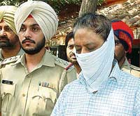 Dr Ravinder Singh Thind in police custody for murdering Visakha Singh in Amritsar on Tuesday.