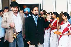 Sheikh Joaan bin Hamad Al Thani (left) of Qatar carries the 2006 Asian Games flame as he walks with president of the Indian Olympic Association Suresh Kalmadi after arriving at the Indira Gandhi International Airport in New Delhi 