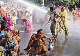 Members of the Anganwadi Employees Union brave the onslaught of water cannons at Matka Chowk, Sector 17, Chandigarh