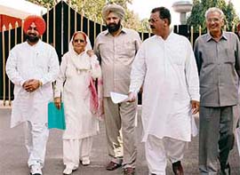 Mr Harjit Singh Grewal, secretary of the BJP, along with other leaders come out of Punjab Raj Bhavan after submitting a memorandum to the Governor on Thursday in Chandigarh.