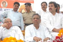 Former Chief Minister Bhajan Lal and his son Kuldeep Bishnoi at a meeting in Yamunanagar on Sunday.