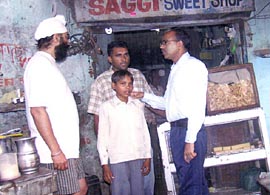 The Deputy Commissioner, Nawanshahr, Mr Krishan Kumar, along with the rescued child labourer in Nawanshahr.