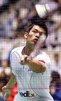 World champion Lin Dan of China plays a return to Taufik Hidayat of Indonesia during the mens singles final of the Japan Open badminton tournament in Tokyo on Sunday