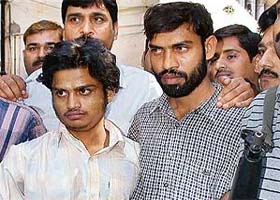 Policemen parade suspected Lashkar-e-Taiba militants Mohammed Aslam Gir and Abdul Razzaq outside police headquarters in New Delhi