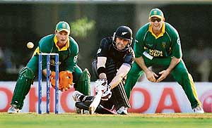 New Zealands Stephen Fleming plays a shot as South Africas Mark Boucher looks on during a Group B match of the ICC Champions Trophy in Mumbai on Monday.