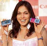 Bollywood actress Isha Koppikar holds Canon cameras at its launch in New Delhi