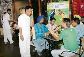 A waiter dressed up in cricket gear at a Mermaid restaurant, Sukhna Lake, Chandigarh
