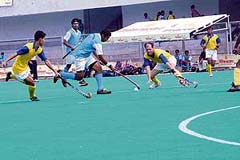 Jagjit Singh of Universities tries to get past Bihar defenders during the Group A match of the 62nd National Hockey Championship at the Olympian Surjit Memorial Hockey Stadium in Jalandhar