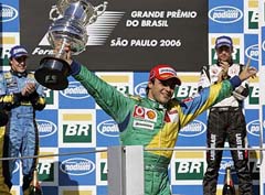 Ferraris Formula One driver Felipe Massa (centre) of Brazil celebrates with Renault's Fernando Alonso (left) of Spain and Lucky Strike Hondas Jenson Button of Britain (right) after finishing first, second and third respectively in the Brazilian Grand Prix in Sao Paulo
