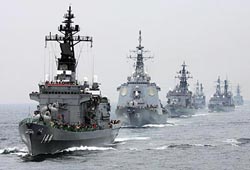 Japanese Maritime Self-Defence Force (MSDF) destroyer Khurama (left) leads the MSDF fleet during a rehearsal ahead of next Sunday's naval fleet review, at Sagami Bay off Yokohama