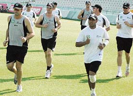 The Kiwis warm up before taking to the nets at PCA Stadium in Mohali on Monday.