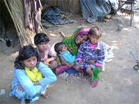 The victims wife, Rekha, along with her children, wails over the murder of her husband.