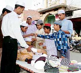 Children buy caps on the eve of Id outside a mosque in Kidwai Nagar in Ludhiana on Monday.  