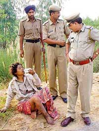 An unidentified woman lying on the Ramgarh-Barwala road is helped by the police on Tuesday