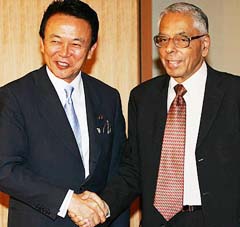 National Security Adviser M.K. Narayanan (right) is welcomed by Japanese Foreign Minister Taro Aso prior to their meeting at Aso's office in Tokyo 