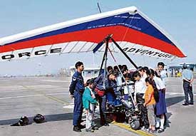 Students being shown the powered hang glider by its pilot, Sqn Ldr Rama Kant, who is attempting a record-breaking trans-India expedition after it touched down in Chandigarh on Wednesday. 