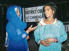 Balbir Kaur, mother of Naresh Kumar, shows her torn clothes outside the District Courts, Sector 17, Chandigarh, on Thursday. 