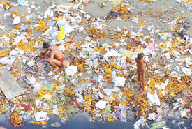 A view of a stretch of the banks of Yamuna littered with bags full of discarded puja flowers even as Chhath celebrations, a festival signifying cleanliness, began on Thursday.
