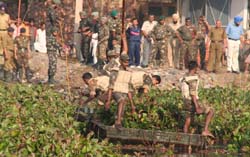 Army jawans try to locate the body of a liquor vend employee from a pond at Lidran village, nearJalandhar,