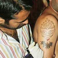 A youth gets his arm tattooed in Ludhiana