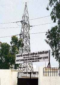 The 220 lakh voltage grid pylon, which supplies power to Amritsar city, stands in Government Saragarhi Memorial Secondary School where students are likely to be shifted from the 155-year-old building. 