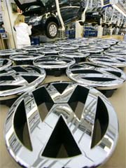 A picture taken on March 2, 2006, shows logos of German car-maker Volkswagen (VW) lying beside an assembly line where Golf V cars are manufactured at the company's plant in Wolfsburg, central Germany.