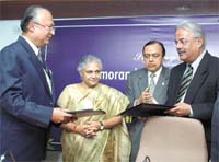 Delhi Chief Minister Sheila Dikshit witnessing the signing ceremony.