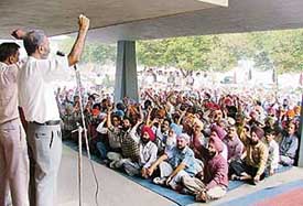 PAU employees hold a dharna in support of their demands in Ludhiana on Friday.