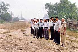 BJP leaders stand on the incomplete overbridge in Civil Lines to register their protest in Ludhiana on Friday. 
