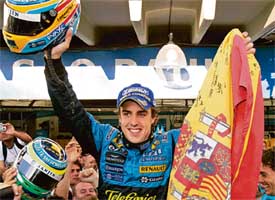 Fernando Alonso overcame a stiff challenge from Michael Schumacher to win his second Formula One title in a row