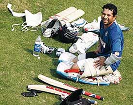 Master Blaster Sachin Tendulkar writhes in pain after a ball from Munaf Patel hit him during a practice session at PCA Stadium in Mohali