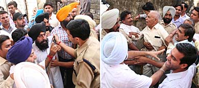 Police officers try to persuade SAD-BJP activists (left) and Congress workers to remain calm outside a polling booth during the byelection of ward no. 33 of the Municipal Corporation in Jalandhar on Saturday.