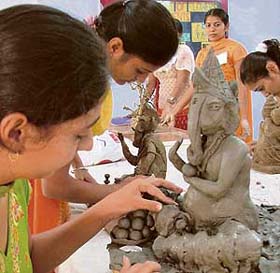 Students give final touches to their entry in the clay modelling competition during a youth festival in Ludhiana
