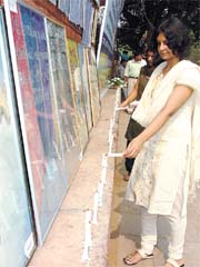 A girl lights up a candle in memory of the victims of Sarojini Nagar bomb blast who lost their lives one year ago, in the Capital.