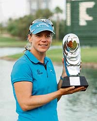Annika Sorenstam of Sweden holds her trophy after winning the Dubai Ladies Masters golf tournament in Dubai