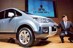 Japan's Mitsubishi Motors Corp President Osamu Masuko unveils mono-box minivan "Delica D:5" at the company's headquarters in Tokyo on Monday.