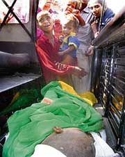 Wailing relatives of a child who killed after getting trapped in a machine at a village in Mohali on Monday.